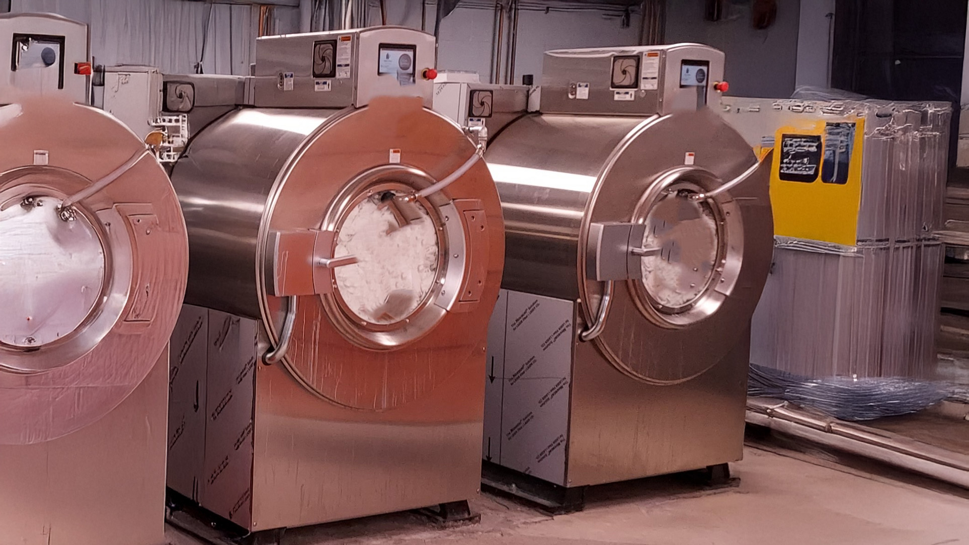 Large commercial washing machines in warehouse